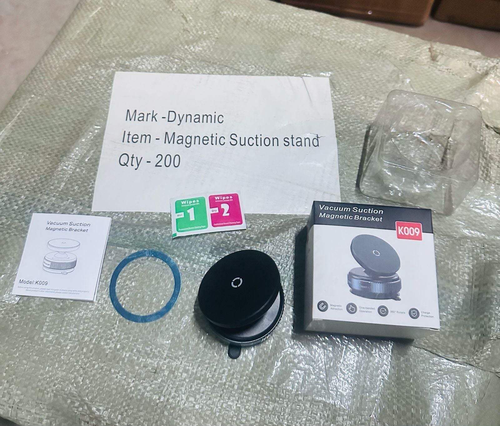 Magnetic suction stand with packaging and accessories on a reflective surface